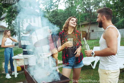 Image of Group of friends making barbecue in the backyard. concept about good and positive mood with friends