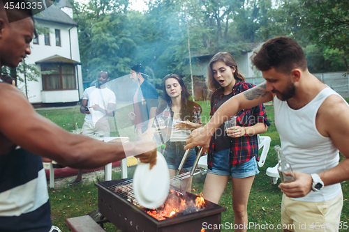 Image of Group of friends making barbecue in the backyard. concept about good and positive mood with friends