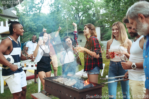 Image of Group of friends making barbecue in the backyard. concept about good and positive mood with friends