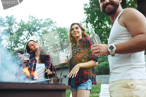 Image of Group of friends making barbecue in the backyard. concept about good and positive mood with friends