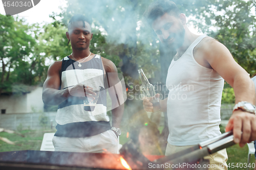 Image of Group of friends making barbecue in the backyard. concept about good and positive mood with friends