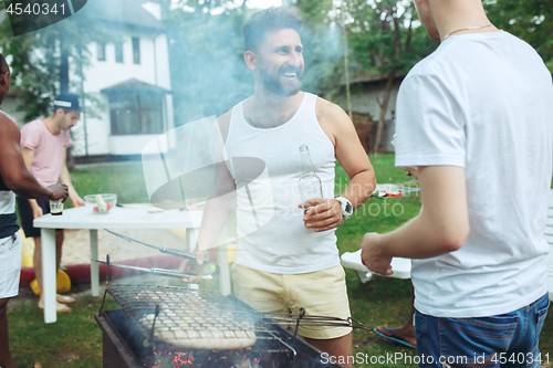 Image of Group of friends making barbecue in the backyard. concept about good and positive mood with friends