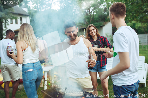 Image of Group of friends making barbecue in the backyard. concept about good and positive mood with friends