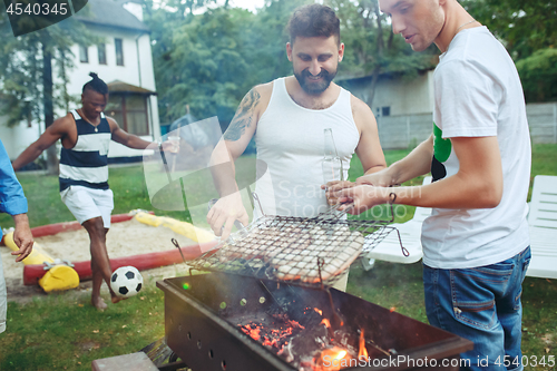 Image of Group of friends making barbecue in the backyard. concept about good and positive mood with friends