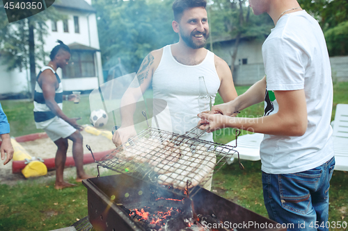 Image of Group of friends making barbecue in the backyard. concept about good and positive mood with friends