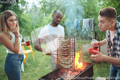 Image of Group of friends making barbecue in the backyard. concept about good and positive mood with friends