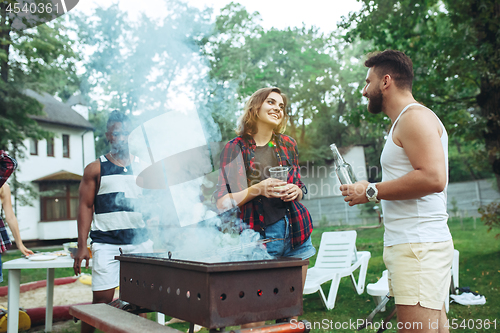 Image of Group of friends making barbecue in the backyard. concept about good and positive mood with friends