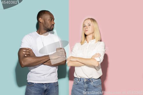 Image of Young serious thoughtful afro man and woman at studio