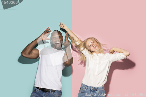 Image of The squint eyed couple with weird expression on blue and pink studio