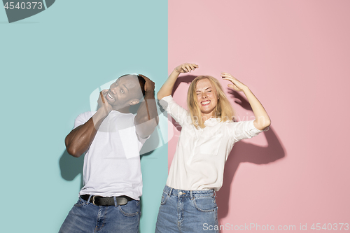 Image of The squint eyed couple with weird expression on blue and pink studio