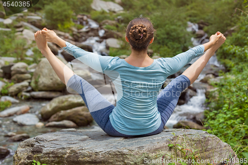 Image of Woman doing Ashtanga Vinyasa Yoga asana outdoors