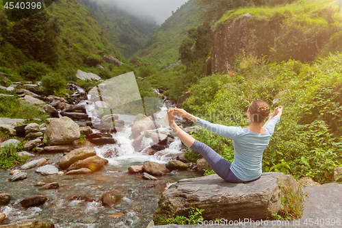 Image of Woman doing Ashtanga Vinyasa Yoga asana outdoors