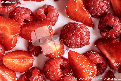 Image of Fresh organic ripe berries with natural milk, close-up view of fruits background.