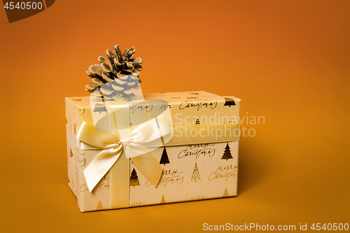 Image of Christmas gift box on orange background