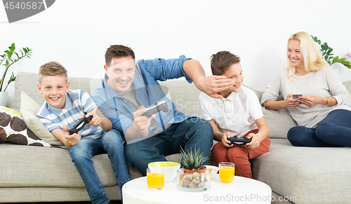 Image of Happy young family playing videogame On TV.