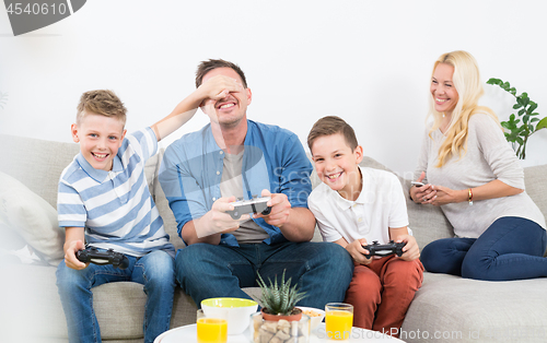 Image of Happy young family playing videogame On TV.