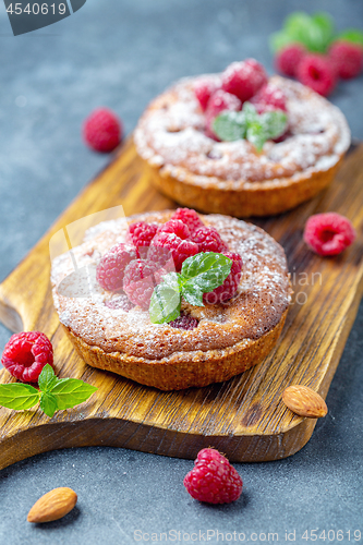 Image of Delicious mini-tarts (tartlets) with raspberries.