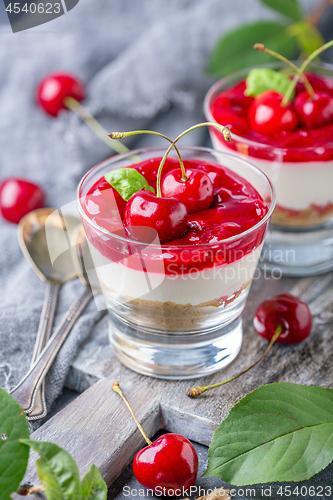 Image of Cheesecake with cherry jelly in a glass close-up.