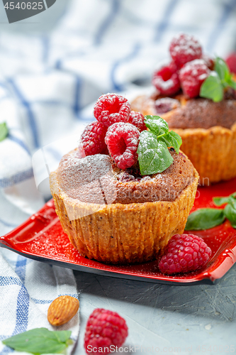 Image of Mini tarts with raspberry, frangipani and mint.