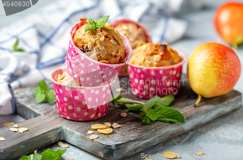 Image of Homemade muffins with pear and granola.
