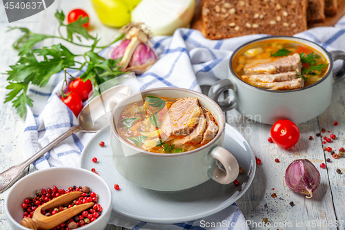 Image of Soup with fresh cabbage and meat in ceramic bowl.