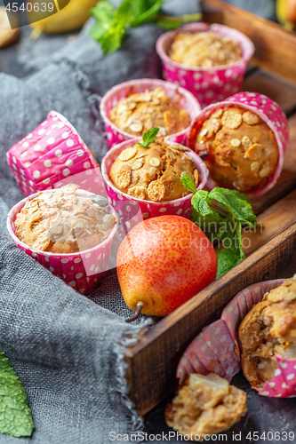 Image of Homemade muffins with pears and muesli.