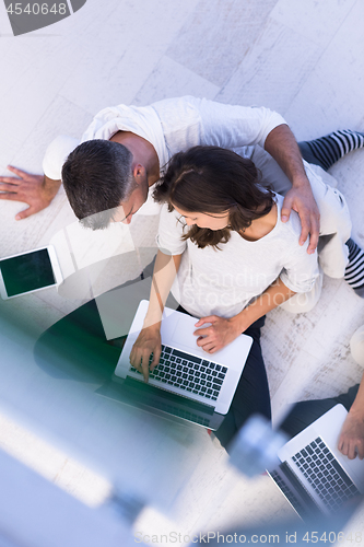 Image of couple using tablet and laptop computers top view