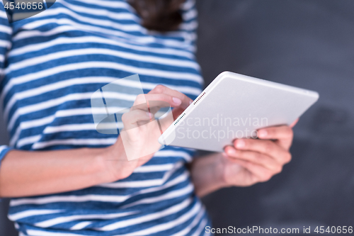 Image of woman using tablet  in front of chalk drawing board