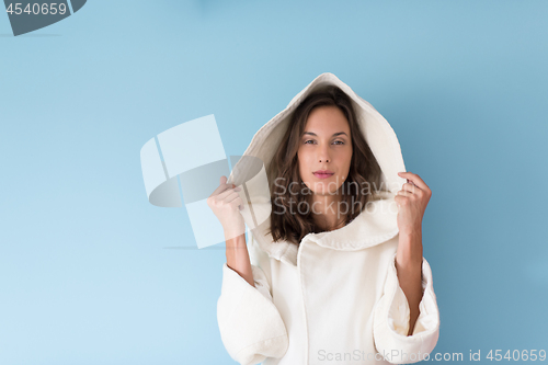 Image of woman in a white coat with hood isolated on blue background