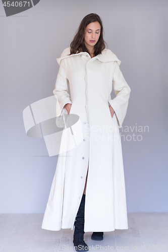 Image of woman in a white coat with hood isolated on white background