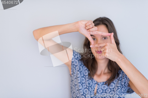 Image of woman showing framing hand gesture