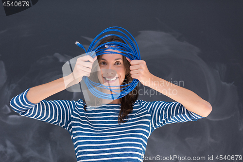 Image of woman holding a internet cable in front of chalk drawing board