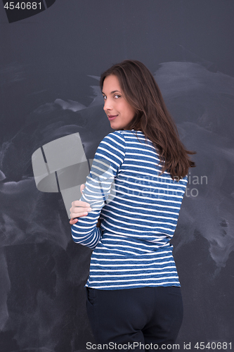 Image of woman standing in front of chalk drawing board