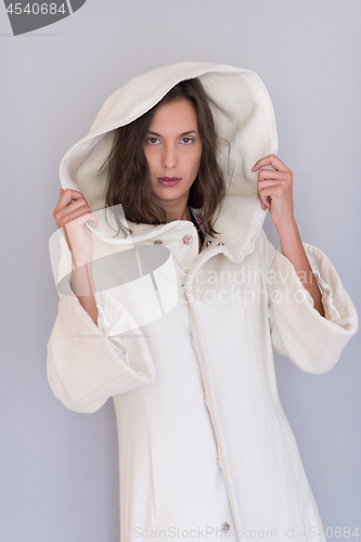 Image of woman in a white coat with hood isolated on white background