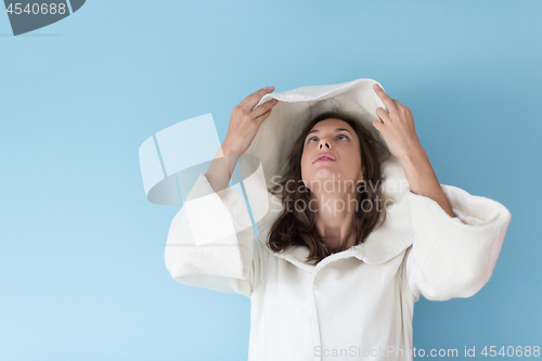 Image of woman in a white coat with hood isolated on blue background