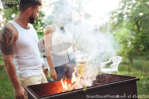 Image of Group of friends making barbecue in the backyard. concept about good and positive mood with friends