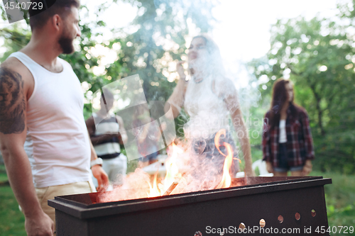 Image of Group of friends making barbecue in the backyard. concept about good and positive mood with friends