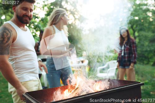 Image of Group of friends making barbecue in the backyard. concept about good and positive mood with friends