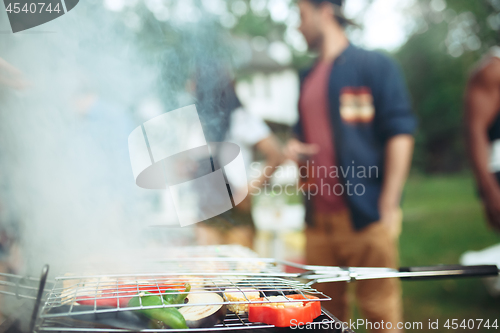 Image of Group of friends making barbecue in the backyard. concept about good and positive mood with friends