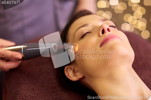 Image of woman having hydradermie facial treatment in spa