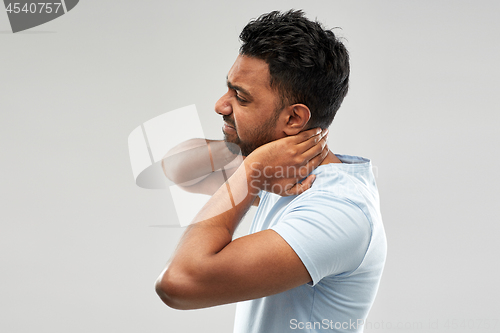 Image of unhealthy indian man suffering from neck pain