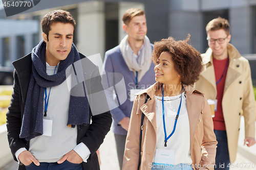 Image of business team with conference badges in city