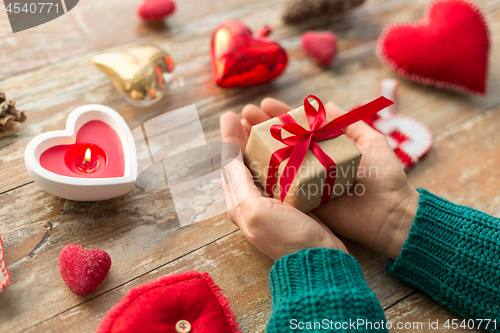 Image of close up of hands holding christmas gift