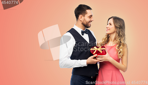 Image of happy couple with gift on valentines day