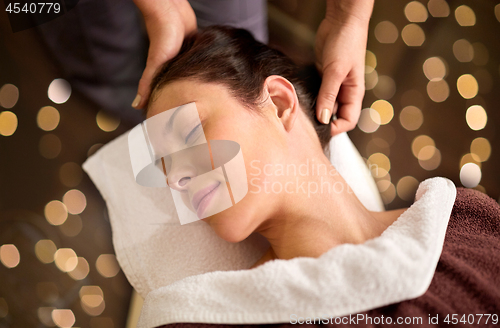 Image of woman having head massage at spa