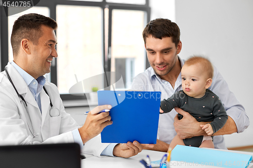 Image of father with baby and doctor at clinic