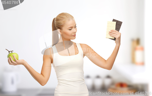 Image of woman choosing between green apple chocolate