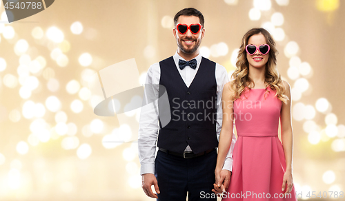 Image of happy couple in heart-shaped sunglasses