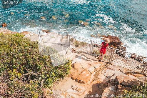 Image of Woman at a fenced lookout over the ocean near Sydney