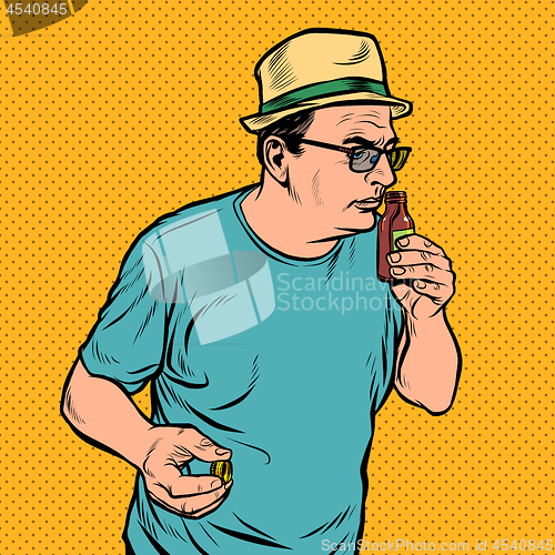 Image of a man sniffs a bottle. perfume or medicine